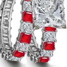 An audacious De Beers ring has a princess center stone on a wide baguette-cut diamond band.