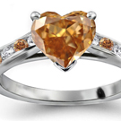 A round brilliant sits in a collet on top of a stylish diamond split-shank ring by H. Stern