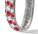 A sporty white gold band by Suzanne Felsen has a round brilliant at the center with diamond studs above and below