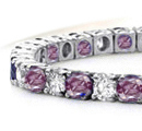made the bracelet in the shape of a garter with a pool of cushion-shaped sapphires at the center of wide diamond bracelet