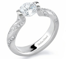A delicious design, Michael B's ring combines a round brillant with a narrow pave-set diamond
band