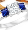 Princess Blue Sapphire Curved Shank Three Stone Ring with Diamonds in 14k White Gold (7X5 mm) 