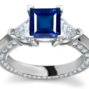 A stunning ring showcases an emerald-cut and tapered baguettes