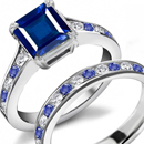 Sleek tapered baguettes hug an emerald-cut in a Scott Kay ring