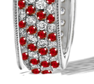 A sporty white gold band by Suzanne Felsen has a round brilliant at the center with diamond studs above and below