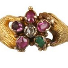 A 16th century amuletic jewelry the ivory hand wearing gold rings set with an emerald and a garnet mounted in filigree enamelled gold to form a pendant spanish mano cornuta was directed against the evil eye